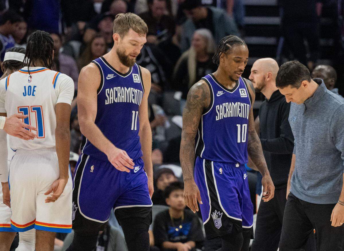 The Sacramento Kings’ Domantas Sabonis (11) and DeMar DeRozan (10) walk off the court as they team loses 130-109 to the Oklahoma City Thunder during an NBA game on Nov. 25, 2024, at Golden 1 Center.