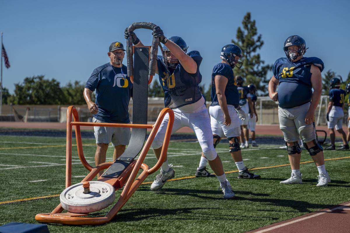 Linemen practice pushing weighted sleds during a football practice at Oak Ridge High School in El Dorado Hills on Tuesday, Aug. 5, 2025.