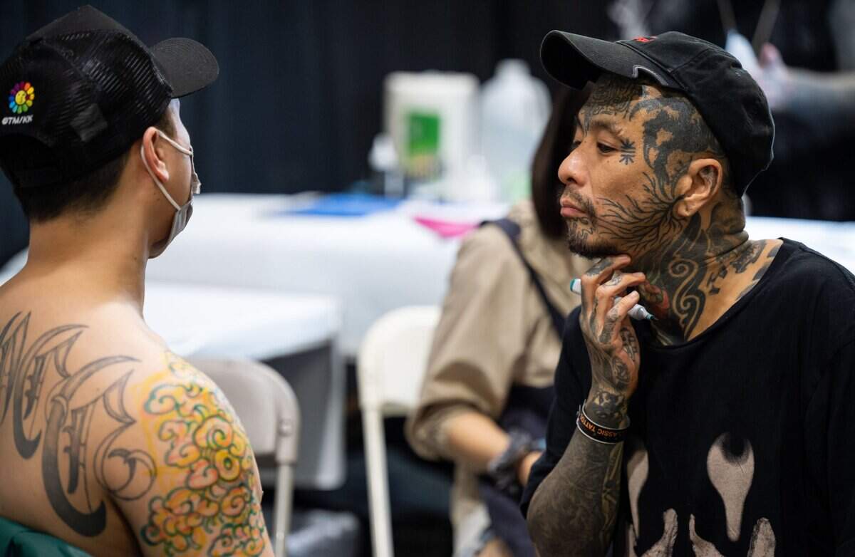 Tattoo artist Bang Ganji, with Capital Tattoo of Melbourne, Australia, visualizes and sketches a tattoo on Duy Do, of San Jose, at the Capitol City Classic Tattoo Conventions first day Friday, May 6, 2022, in downtown Sacramento. Convention CEO Britton McFetridge, a Sacramento native and owner of Royal Peacock Tattoo Parlor, said more than 200 tattoo artists were selected from around the world to attend the inaugural three-day event, set to include live tattooing, seminars and industry vendors at the SAFE Credit Union Convention Center.