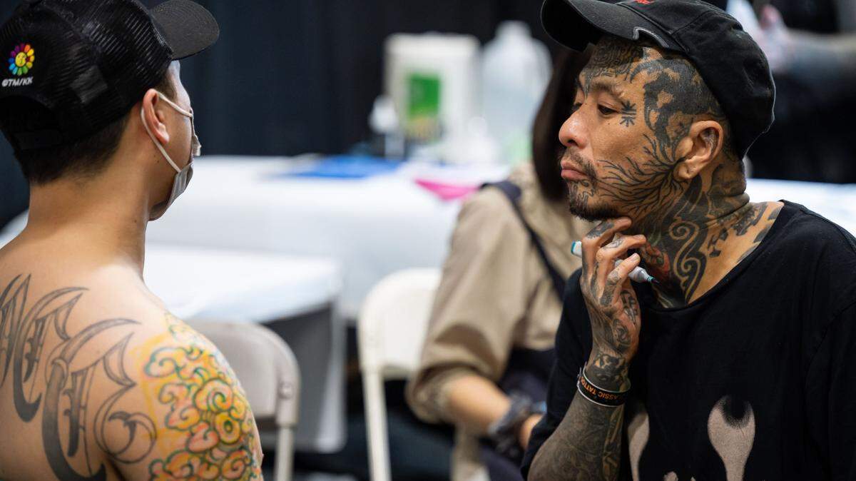 Tattoo artist Bang Ganji, with Capital Tattoo of Melbourne, Australia, visualizes and sketches a tattoo on Duy Do, of San Jose, at the Capitol City Classic Tattoo Conventions first day Friday, May 6, 2022, in downtown Sacramento. Convention CEO Britton McFetridge, a Sacramento native and owner of Royal Peacock Tattoo Parlor, said more than 200 tattoo artists were selected from around the world to attend the inaugural three-day event, set to include live tattooing, seminars and industry vendors at the SAFE Credit Union Convention Center.