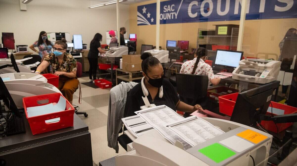 Election workers count ballots in the tabulation room at the Sacramento County Registrar of Voters office in south Sacramento in September 2021.