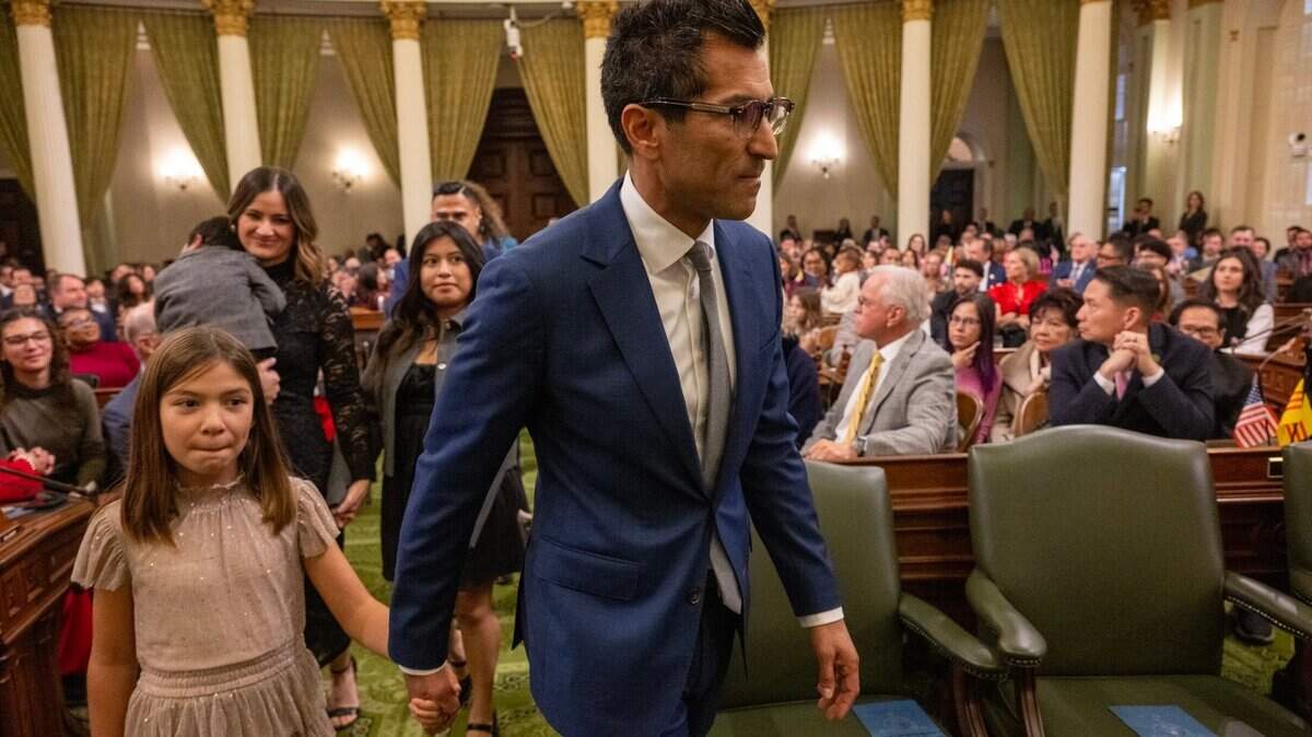 Assembly Speaker Robert Rivas, D-Hollister, walks to the dais with his daughter, Melina, 9, after being sworn in at the state Capitol on Monday, Dec. 2, 2024, during the Assembly’s first meeting of the new legislative session.