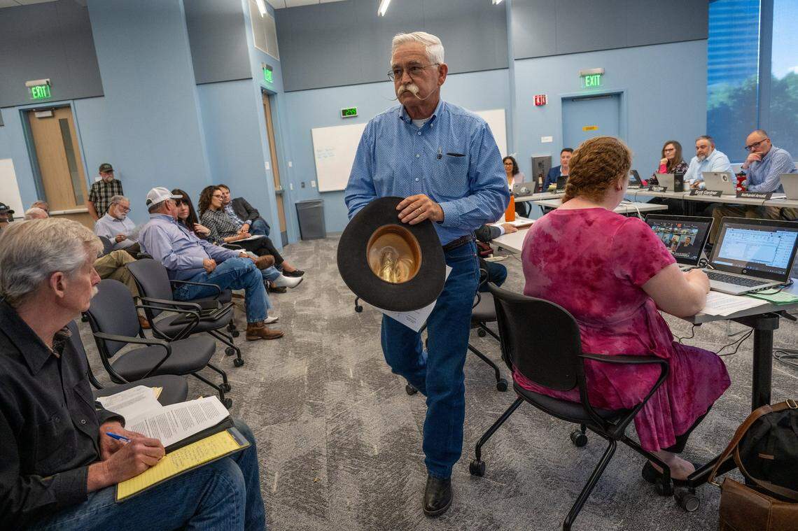 Modoc County Supervisor Ned Coe returns to his seat after speaking about coyotes during public comment portion of a meeting of the California Fish and Game Commission’s Wildlife Resources Committee on Thursday in Sacramento.