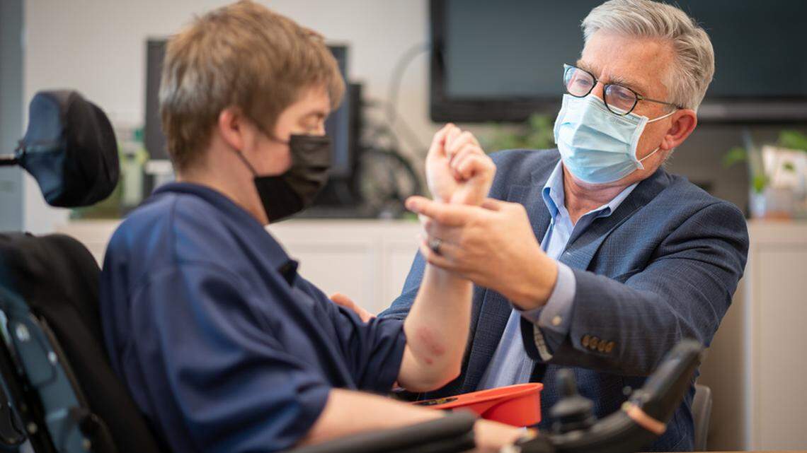 Dr. Craig McDonald, a doctor in the Department of Physical Medicine & Rehabilitation, conferred with patient Hunter Horkheimer at the UC Davis Children’s Hospital in this March 2022 photo.