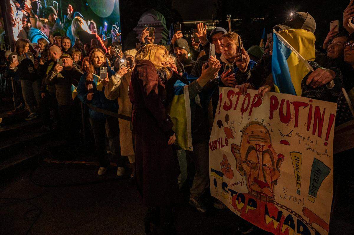 Ukrainian singer Tina Karol takes pictures with the crowd at the state Capitol on Friday.