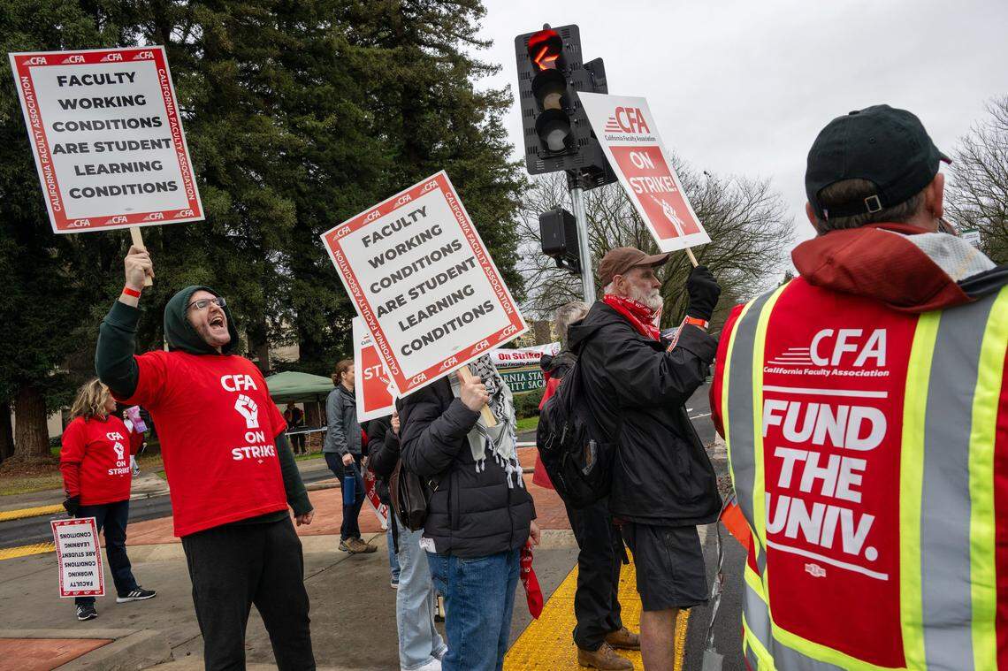 Trevor White, left, a professor in the math department at Sacramento State, joins a weeklong faculty strike at the university on Monday.