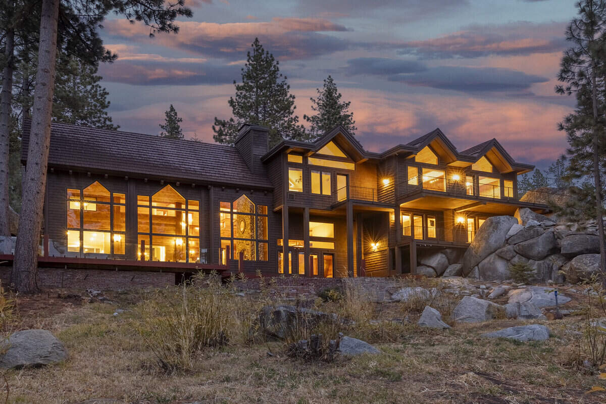 Expansive decks, naturescaped grounds, and smooth granite outcroppings deliver 110 feet of private lakefront for relaxation, sunbathing, or entertaining with panoramic lake views.