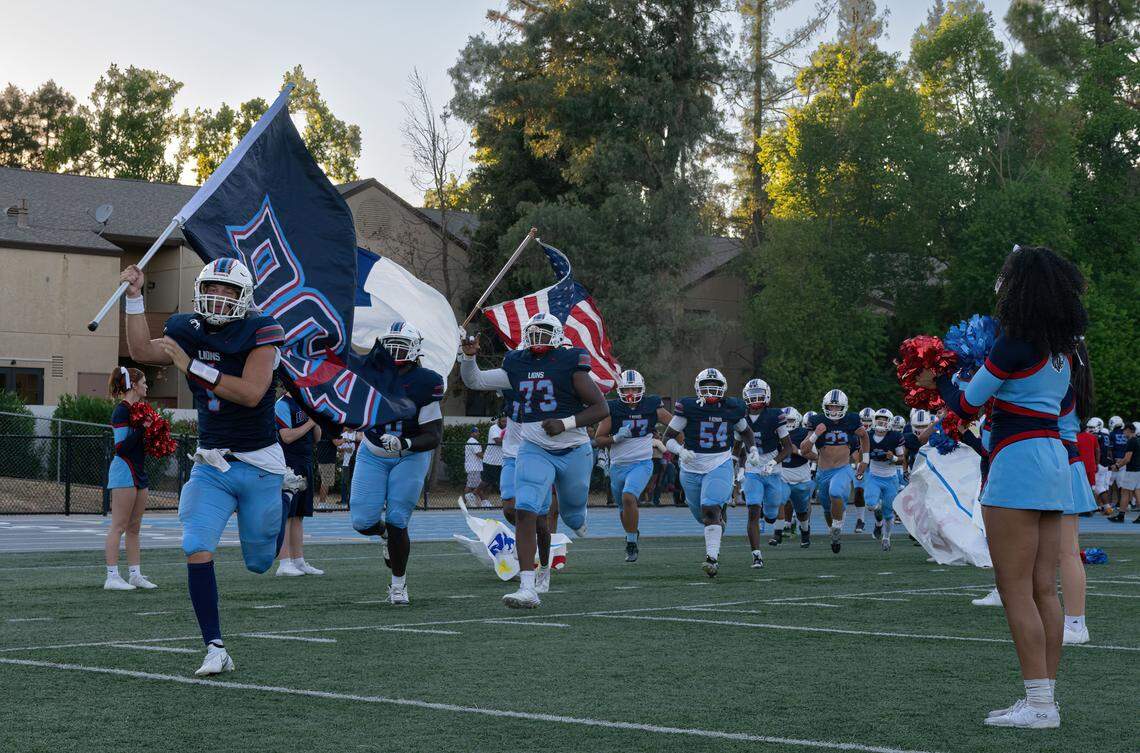 The Destiny Christian Lions, led by quarterback Dallas Munn (1), take the field against the Linden Lions on Friday.