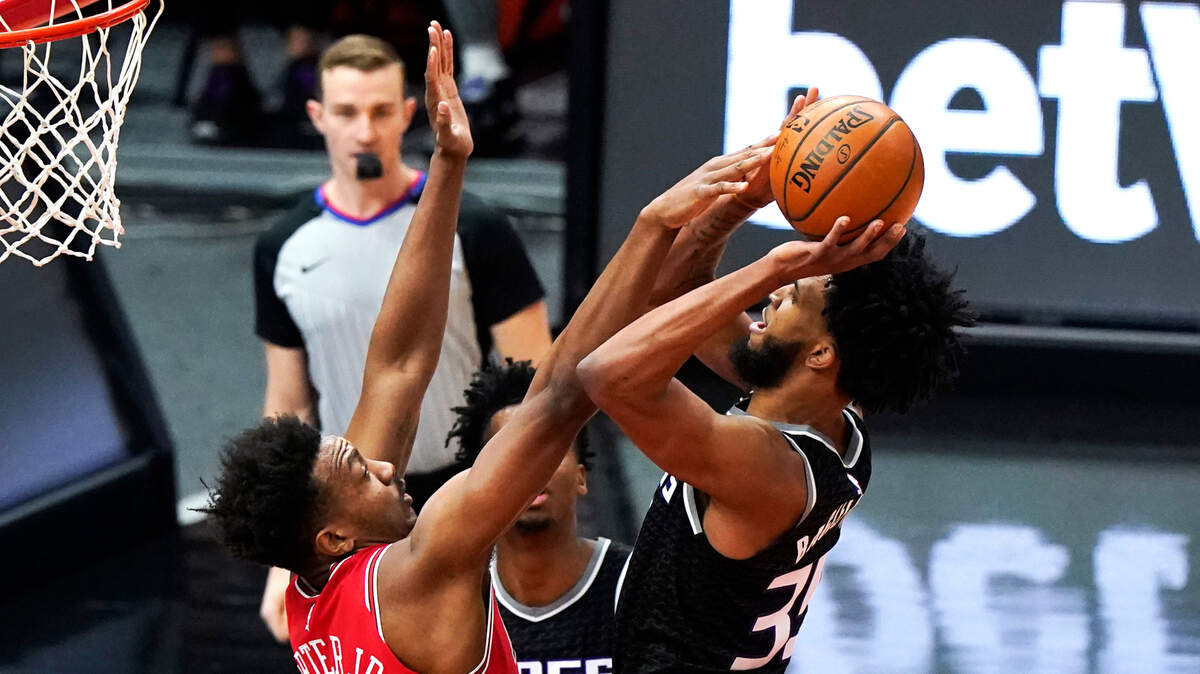 Sacramento Kings forward Marvin Bagley III, right, shoots against Chicago Bulls center Wendell Carter Jr., during the first half of an NBA basketball game in Chicago, Saturday, Feb. 20, 2021. (AP Photo/Nam Y. Huh)