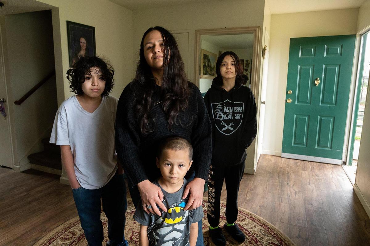 Rosario Correa, 34, and children Arthur Gamino Correa, 12, Michael Gamino Correa 5, and Guadalupe Gamino Correa, 15, at home on Thursday, March 18, 2021 in Sacramento. The single Latino mother changed her work schedule to a night shift to help supervised her three children’s schooling during the day.