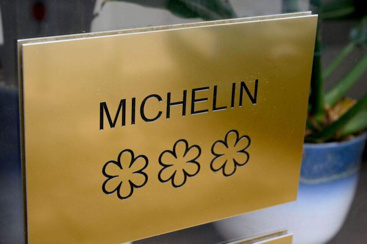 A plaque displaying the three stars of the Michelin guide, the highest award of the French gastronomy, on the door of Alexandre Mazzia's AM restaurant.