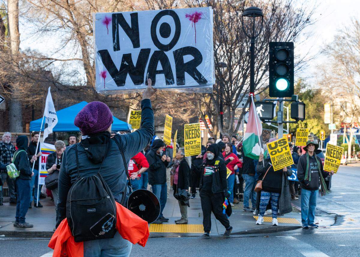 A protester with a “No War” sign joins a demonstration in Sacramento on Saturday, Jan. 3, 2026, against U.S. military action in Venezuela after President Donald Trump announced a bombing raid on the country and the capture of its leader. 