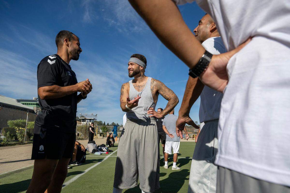 A Sacramento Republic FC player talks with an inmate at Folsom State Prison before a scrimmage match Tuesday.
