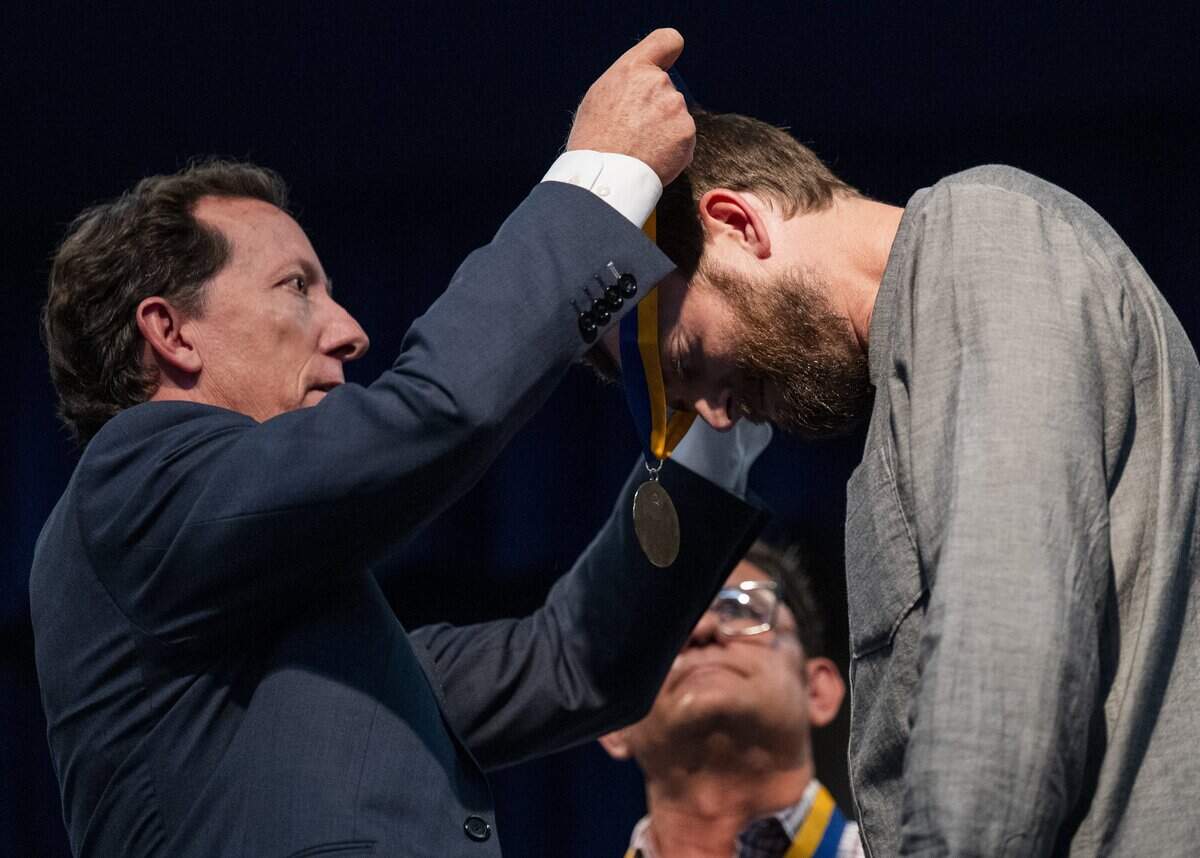Caltrans landscape architect Tobin Hook receives a gold Governor’s State Employee Medal of Valor at the California Highway Patrol Academy in West Sacramento on Friday.