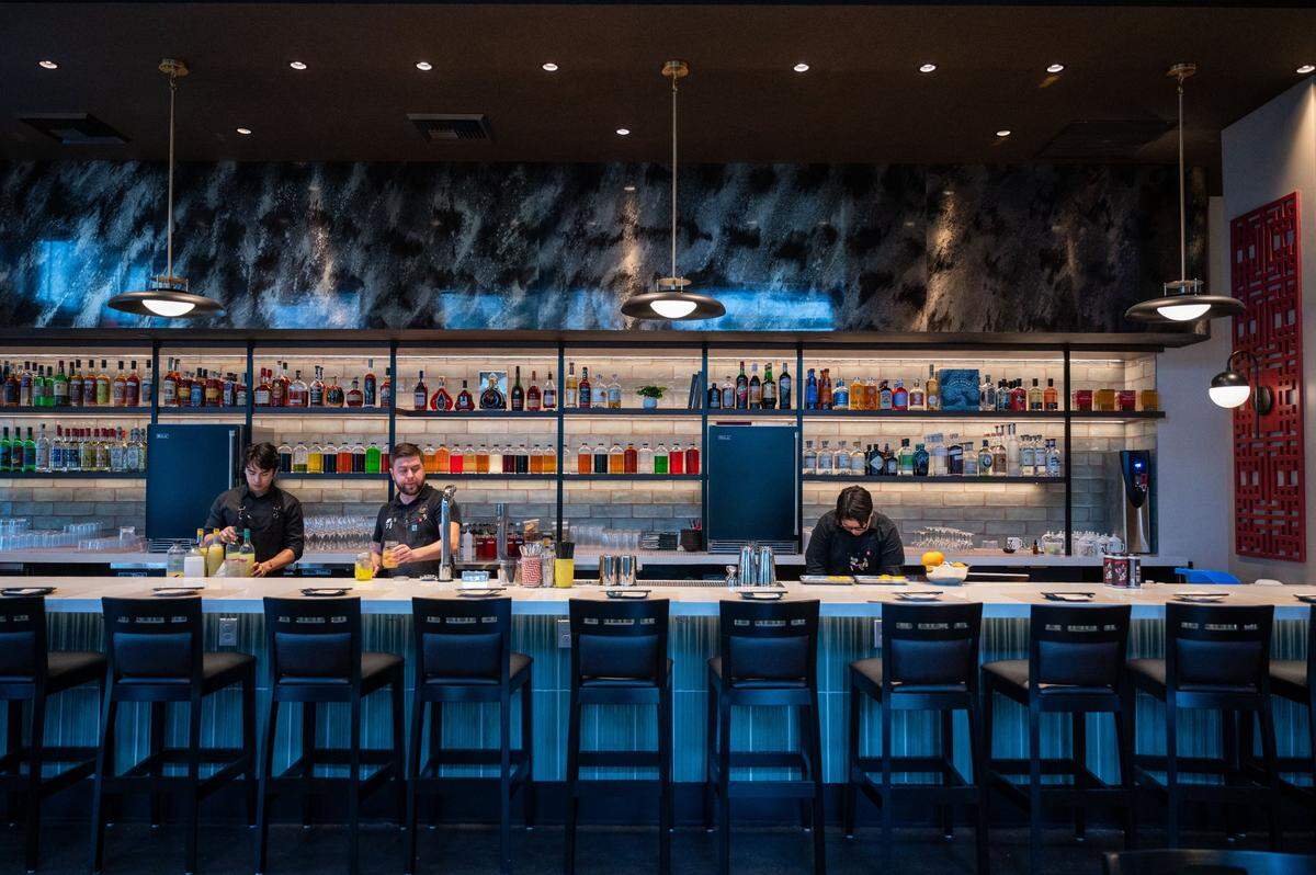 The staff at Chu Mai prepare for customers behind the bar filled colorful bottles at the midtown Sacramento restaurant earlier this month.