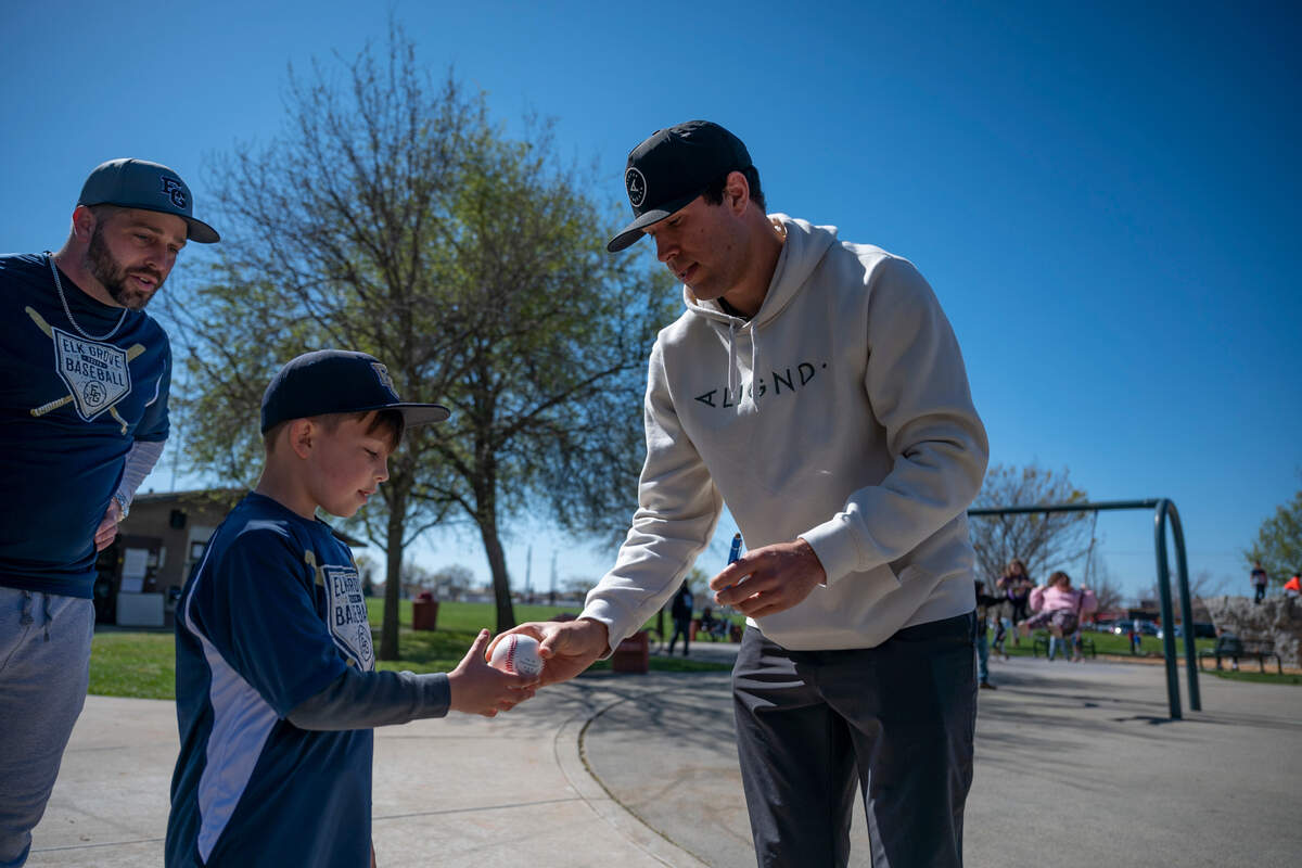St. Louis Cardinals outfielder Dylan Carlson signs a baseball for a youth player on March 6 at Elk Grove’s Rau Park.