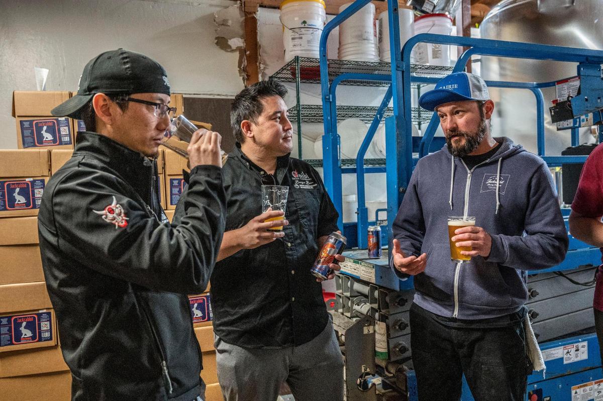Jared Wong, left, Kenichiro Hirsch and Robert Moreno taste Onibi’s Big Shachihoko Hazy Shiso IPA at Jackrabbit Brewing in West Sacramento.