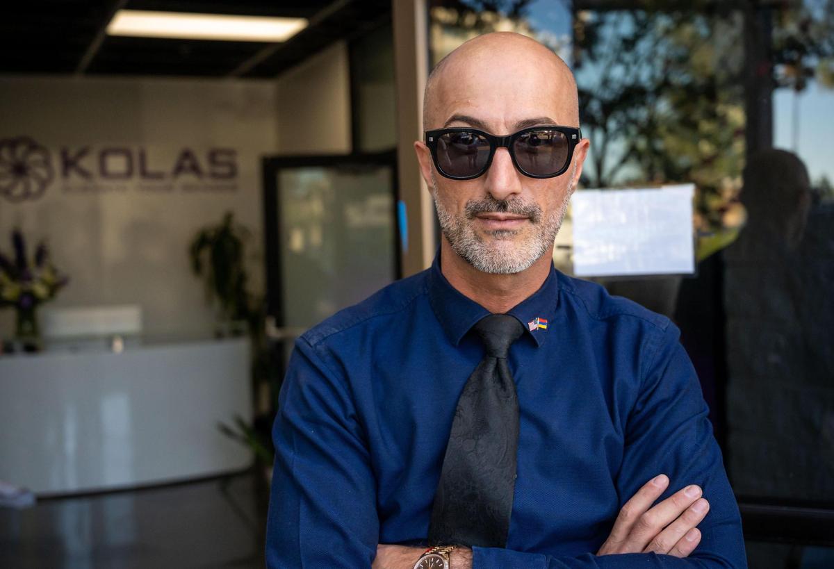 Co-owner Garib “Justin” Karapetyan stands outside the new Kolas retail store and resource center along the Arden shopping corridor in Sacramento on Wednesday, during a party the evening before opening for business.