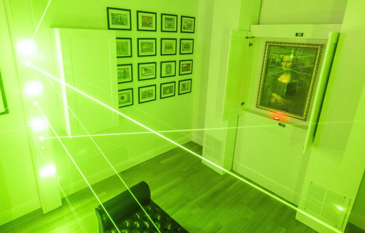 Light beams protect the "Mona Lisa" in the “Who Stole Mona?” room at Escapology at Downtown Commons during its grand opening on Wednesday.