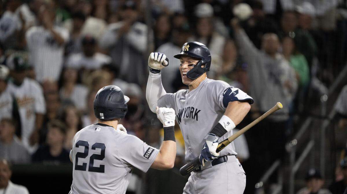 New York Yankees hitter Aaron Judge celebrates after a home run hit by Ben Rice (22) in the seventh inning against Athletics pitcher Scott Barlow on Friday at Sutter Health Park in West Sacramento.