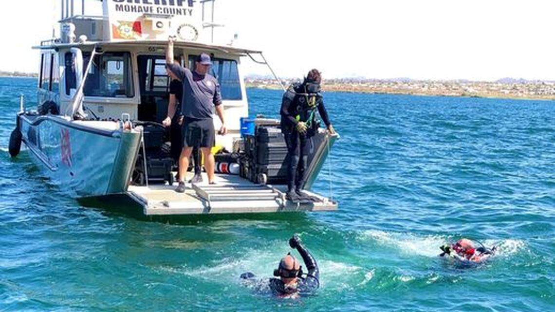 Divers look for the body of a 16-year-old boy who drowned Sunday on a pontoon boat outing on Lake Havasu on the California-Arizona border.