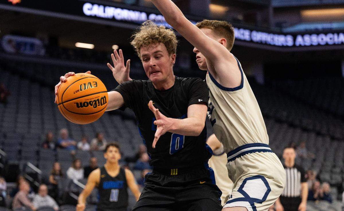 The Sacramento Waldorf Waves’ Liam Aldwinckle (0) attempts to control the ball as he’s defended by the Stone Ridge Christian Knights’ Tyler Mccabe (22) during a CIF Sac-Joaquin Section Division VI boys basketball championship game at Golden 1 Center on Thursday, Feb. 27, 2025.
