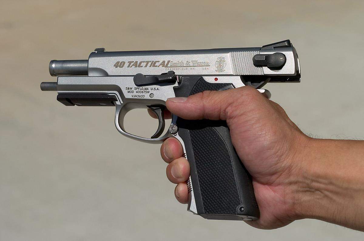 A California Highway Patrol officer demonstrates a CHP handgun at the academy range in West Sacramento. The agency returned Lt. Brad Wheat's weapon to him two weeks before he used it to kill his estranged wife and himself.