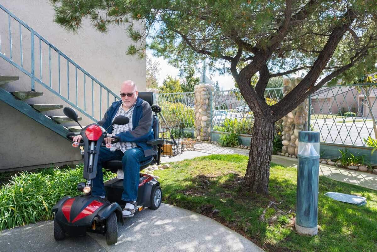 Lloyd Tennison, a Medi-Cal enrollee who moved to Stockton last year, has severe pain in his back and neck that restricts his mobility. He uses a motorized scooter to get around.