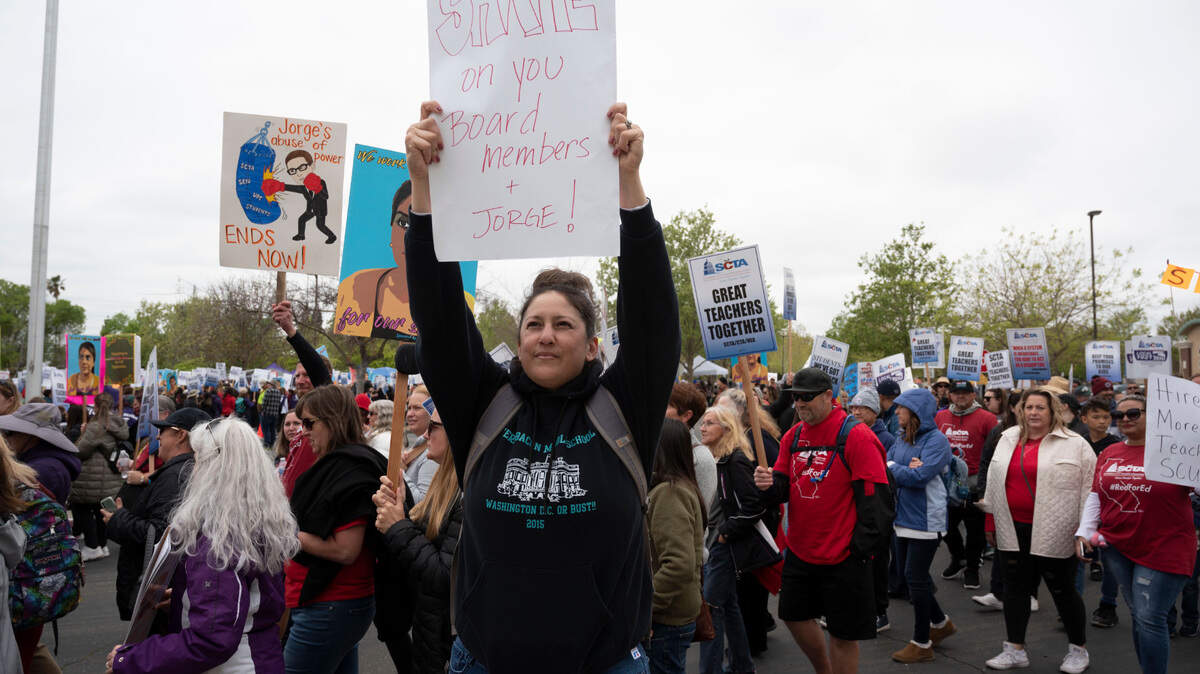 Yvette Menefee, a school counselor at Fern Bacon Middle School, holds up a sign in front of the Serna Center on Wednesday, March 30, 2022, on Day 6 of the Sacramento city teachers’ strike.