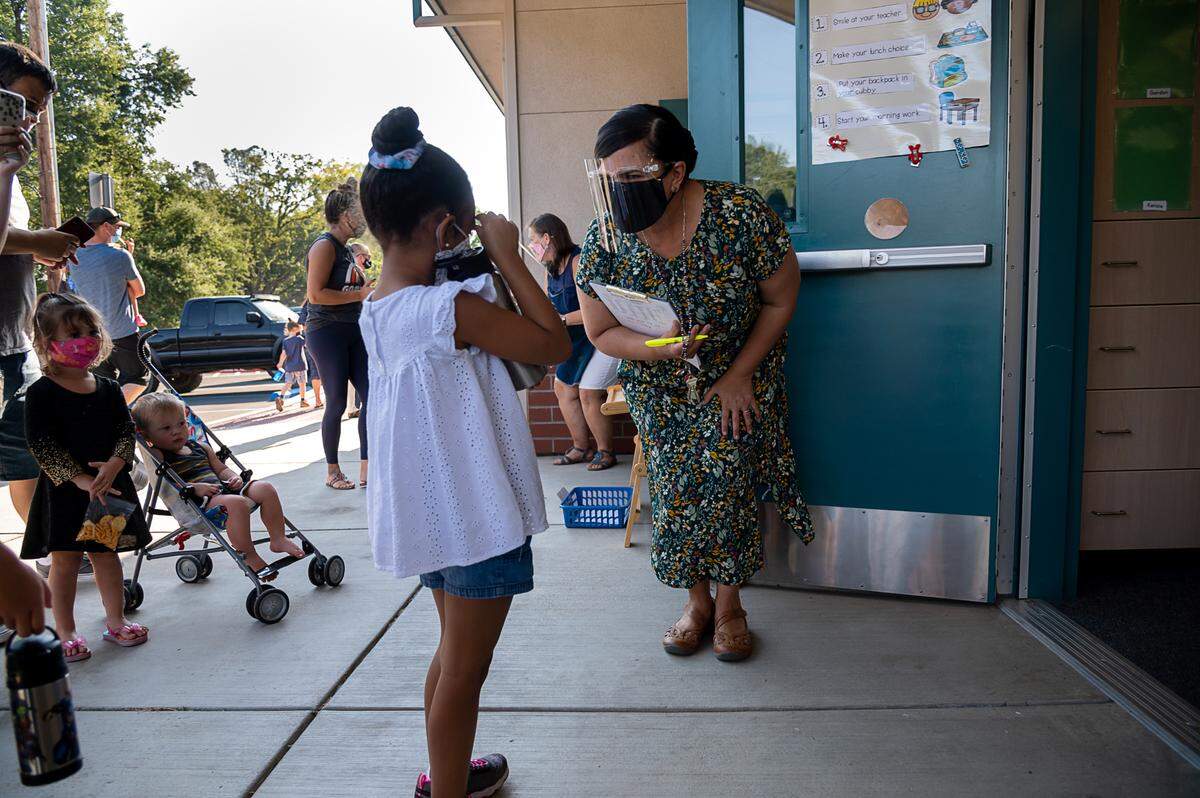 Kindergarten teacher Angelica Garcia greets Kenzie Burse, 5, during the first day of school at Rescue Elementary School on Monday, Aug 17, 2020 in Rescue.