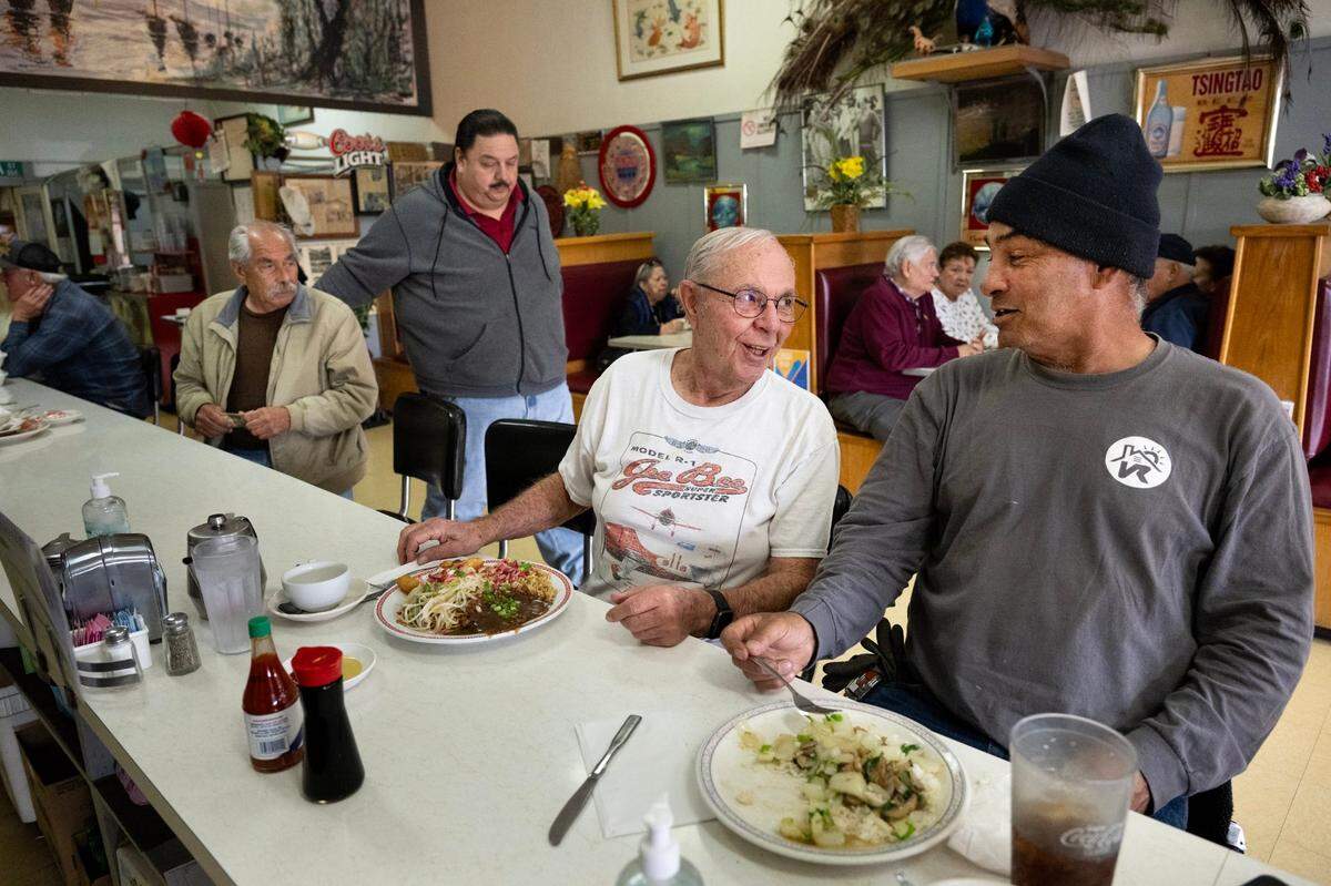 First time customer Dick Williams, left, sits at the counter with Felix Cano who has been coming to the Chicago Cafe for 55 years on Feb. 23, in Woodland. Generations of families have been coming here and UC Davis recently confirmed that Chicago Cafe is the oldest Chinese restaurant in California.