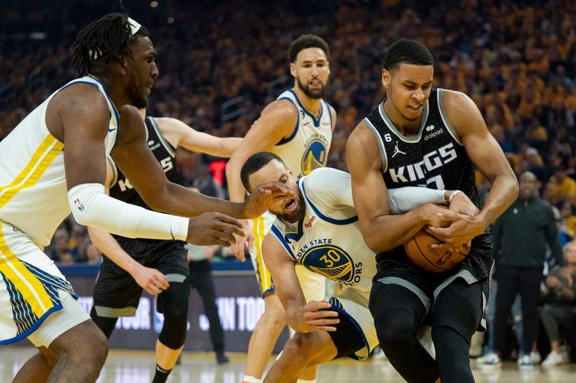 Sacramento Kings forward Keegan Murray (13) battles Golden State Warriors guard Stephen Curry (30) for rebound during Game 4 of the first-round NBA playoff series at Chase Center in San Francisco on Sunday.