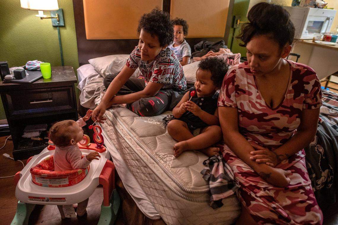 Ashley Patterson stays at the Extended Stay America motel in Sacramento in May with children Jason Brooks Jr., 11, Angel McDew, 9 months, in walker, Ashton McDew, 5, back center, and Allayah Walker, 2, right. She says it is frustrating for the family of five to live in a cramped room, but “everywhere I call, they tell me there’s nothing available.”