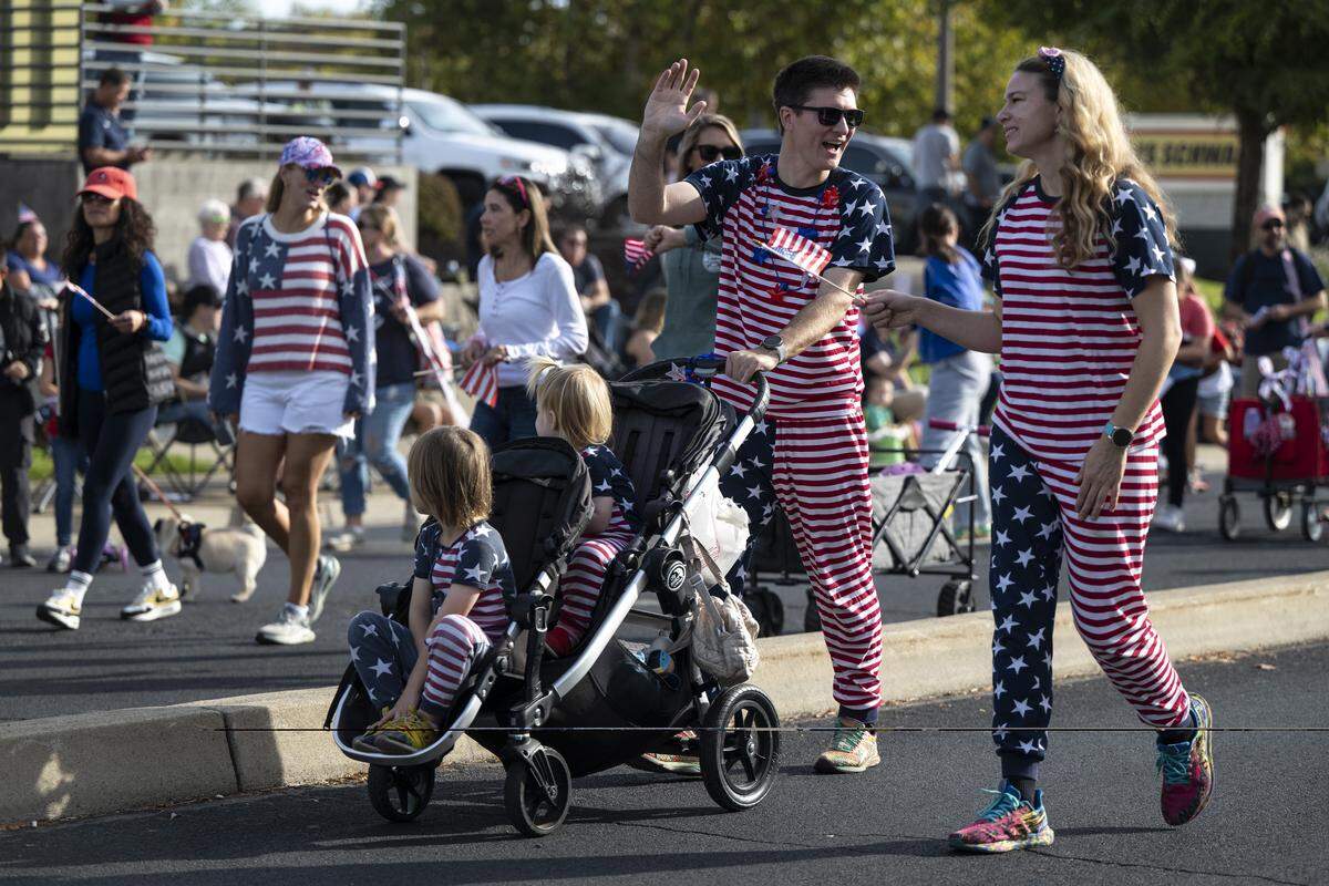 Parade participants march down East Bidwell Street during a Veterans Day parade in Folsom on Tuesday, Nov. 11, 2025.