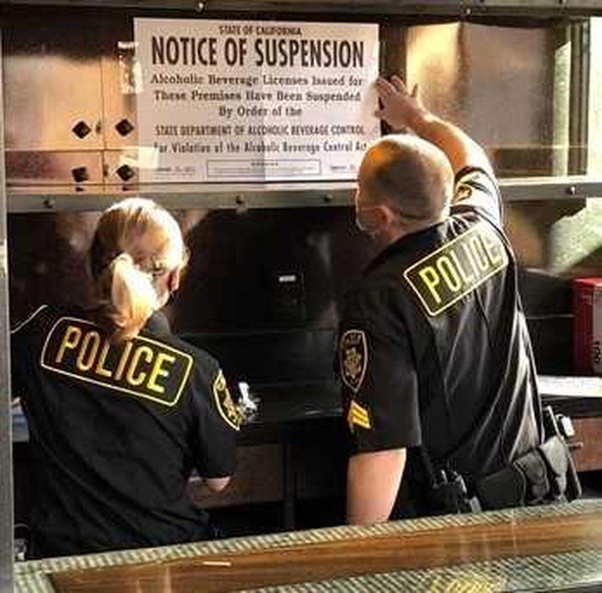 Agents from the California Department of Alcoholic Beverage Control on Friday Jan. 15, 2021, posted a notice of suspension sign at Catch a Wave by Blue Nami restaurant in Folsom, California. The restaurant’s alcohol license was suspended for 45 days is the result of an investigation that led to the arrests of two employees accused of serving alcohol to an underage worker the night she died in a crash.