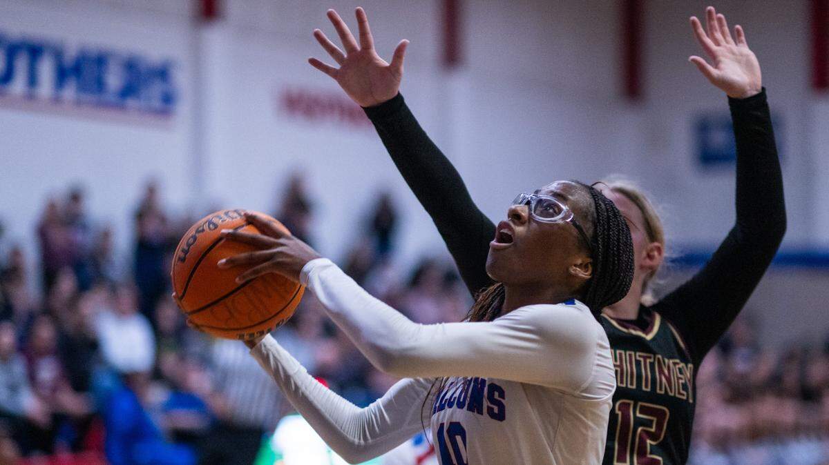The Christian Brothers Falcons’ Joy Omishakin (10) scores a layup against the Whitney Wildcats’ Tylie Kitchen (12) in the second overtime of a CIF Sac-Joaquin Section Division III semifinal girls basketball game on Tuesday in Sacramento.
