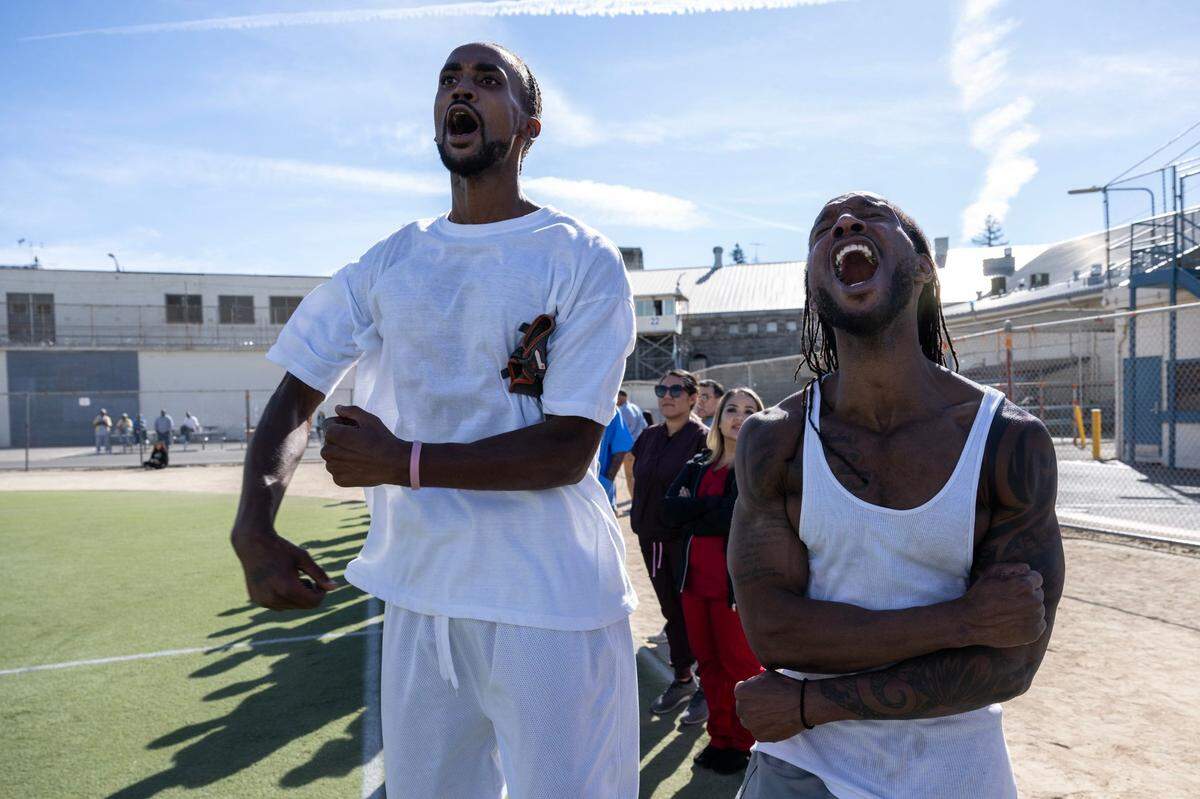 Folsom State Prison inmates, Jamar Meneesse and Miles Sharp, react as their team scores their 5th goal during a scrimmage against the Sacramento Republic FC players Tuesday.