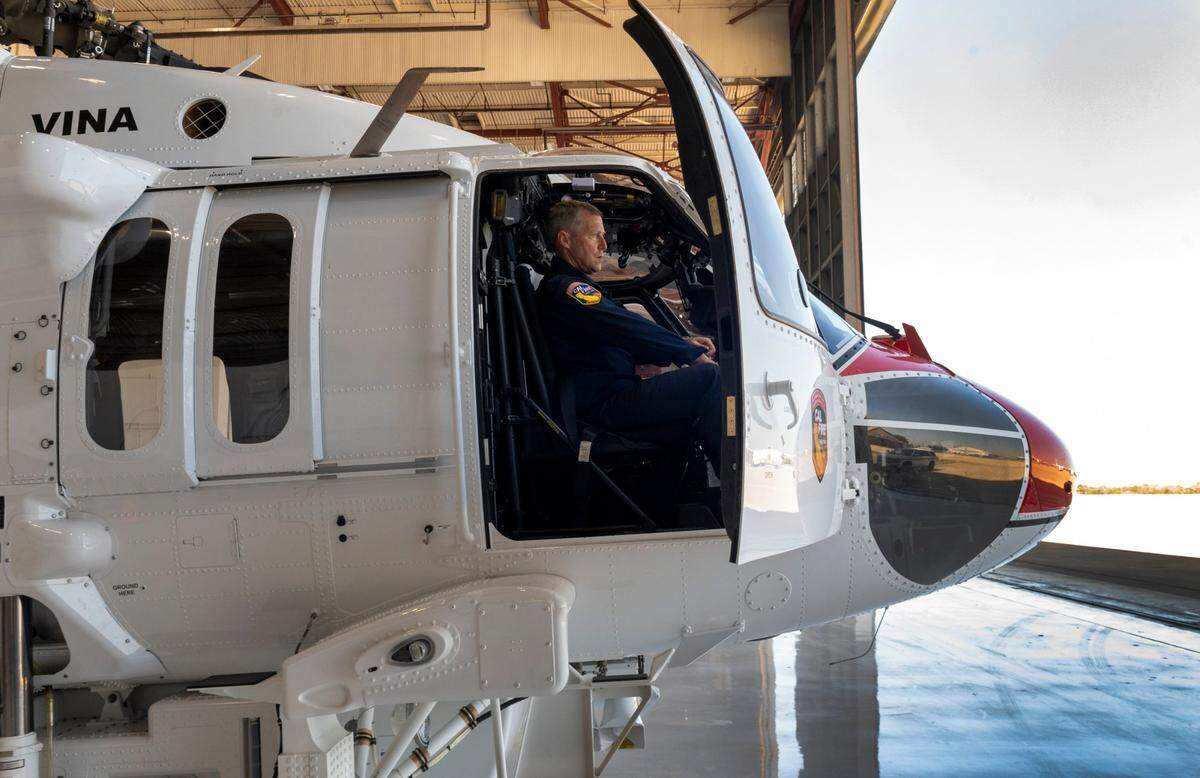 Cal Fire pilot Brent Starr gets a Firehawk helicopter ready for takeoff at the Sacramento McClellan Airport on Thursday, July 2, 2020.