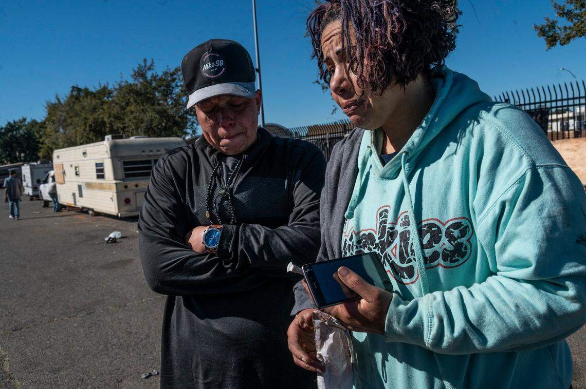 Lyoana Medek-Starks, 37, right, and Sharie Dickerson, 39, left, shed tears after their RV was towed by city crews along Evergreen Street on Wednesday. They said their other vehicle burned and they had just purchased new stuff after moving into the RV nine days ago.