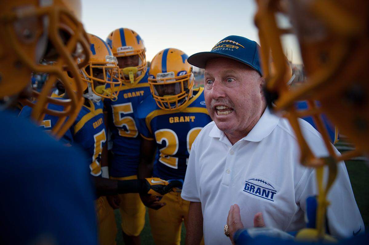 Grant High School football coach Mike Alberghini talks with his offensive squad before a game with Paradise High School at Grant in Sacramento on Aug. 24, 2012.