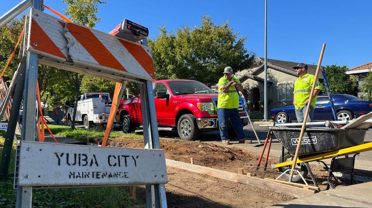 Yuba City maintenance division workers Jose Valero and Ryan Armore stand at a job site repairing a stretch of sidewalk on Ross Drive on Thursday, Sept. 19, 2024.