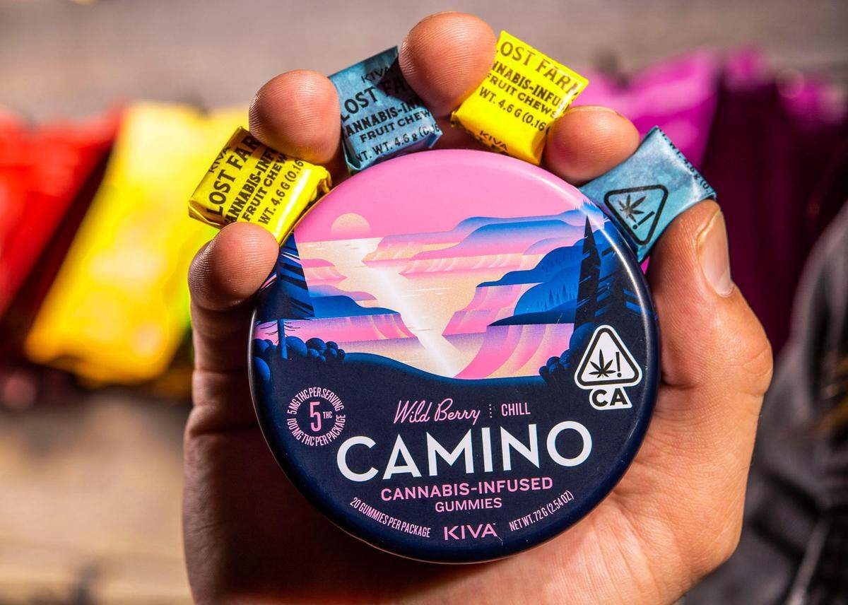 Chandler Hale holds some of the cannabis-infused edible gummies and fruit chews available Tuesday at All About Wellness dispensary in midtown Sacramento.