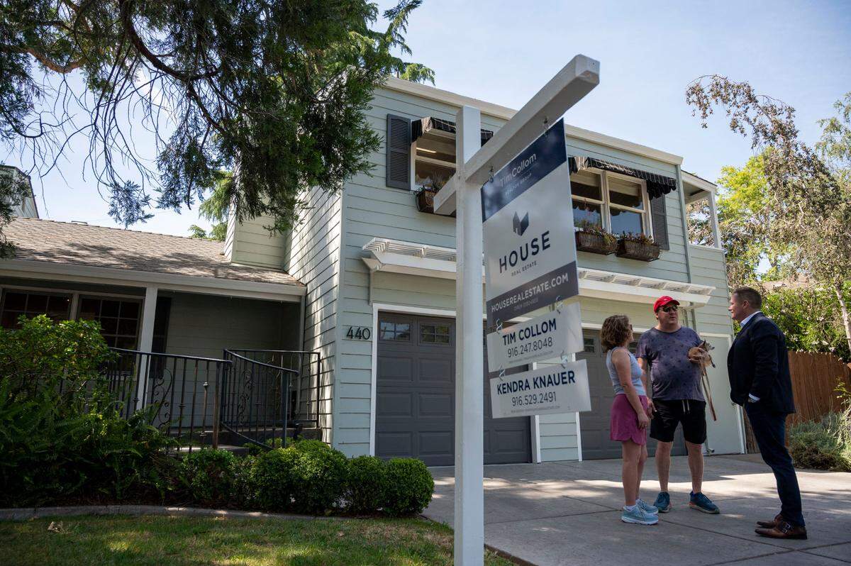 Sacramento real estate agent Tim Collom, right, talks with Dale and Debbie Snapp outside an open house Saturday in East Sacramento. Collom said the spring housing market is still strong but has slowed from two months ago. Homes that were getting five to 10 offers earlier this year are now attracting one or two.