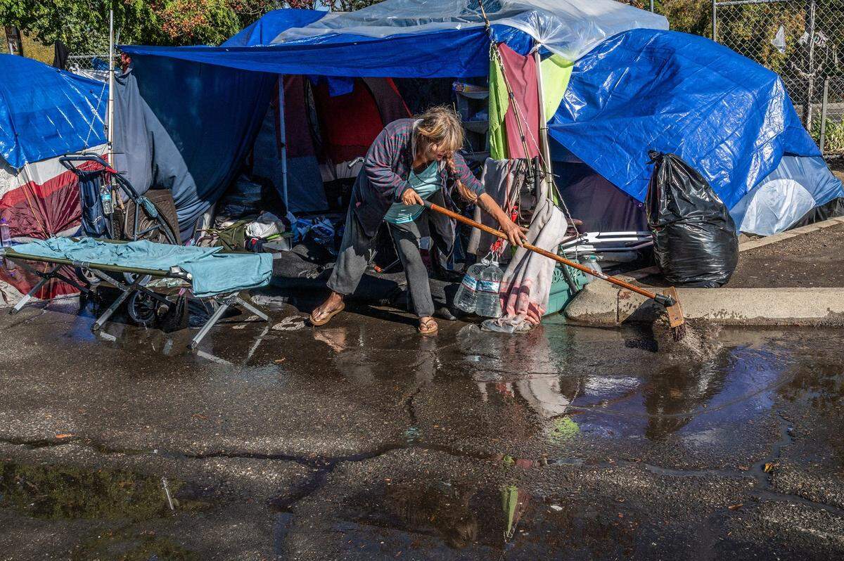 Wendy Corron, 54, said she had to go out and buy her own sand bags and her tent still got flooded at a Safe Ground homeless encampment as she tried to sweep away excess water after a big storm last October.