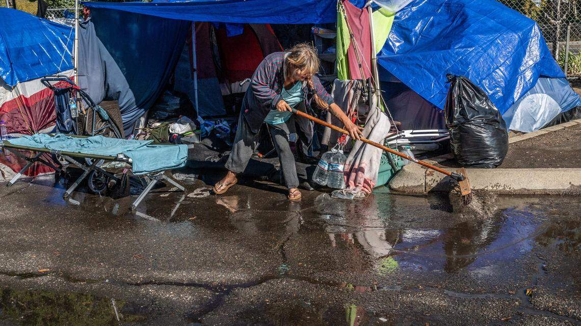 In this Oct. 2021 file photo, Wendy Corron, 54, said she had to go out and buy her own sand bags to deal with flooding at a Safe Ground homeless encampment.