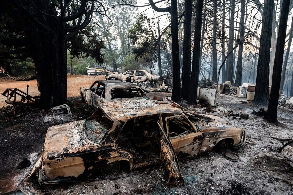 A set of melted cars stand on the rubble of a burned down home during the River Fire on Mount Olive Road in Chicago Park on Thursday, Aug. 5, 2021.