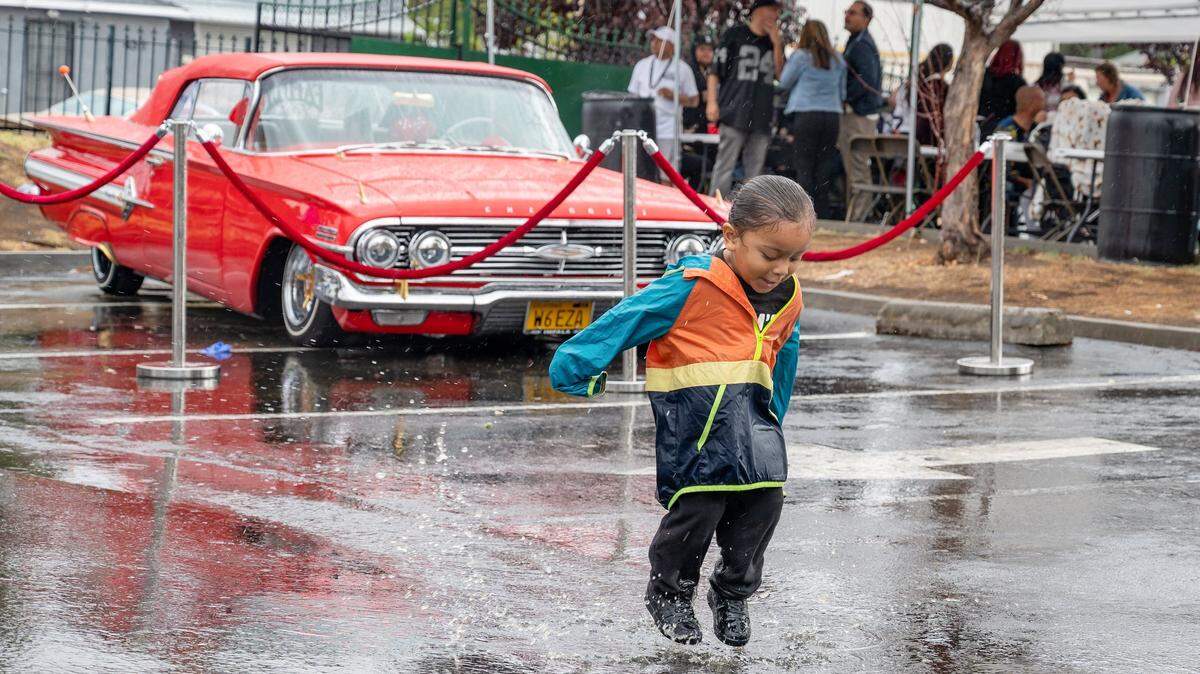 Reddington Vinson, 2, jumps in puddles during Back to the Boulevard, a Mexican Independence Day Festival on Franklin Boulevard in Sacramento that promised to feature more than 600 classic cars, on Sunday. The street was a popular cruising destination in the 1970s and 80s.