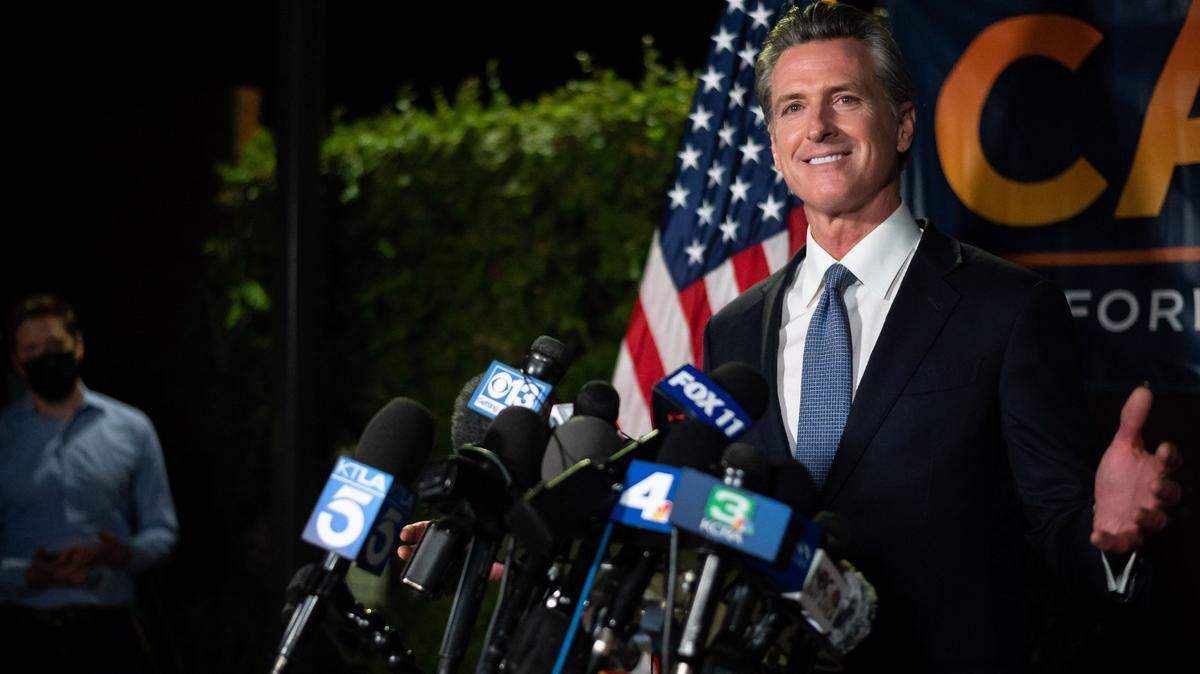 Gov. Gavin Newsom gives a statement to news media shortly after polls closed across the state, with early results giving him a clear lead and the Associated Press calling the recall election in his favor, on Tuesday, Sept. 14, 2021, at the California Democratic Party Headquarters in Sacramento.