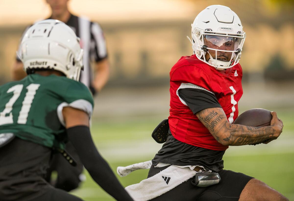 Sacramento State quarterback Kaiden Bennett runs with the football for a gain as safety Kylen Ross pursues him to the sideline during a scrimmage earlier this month at Hornet Stadium.