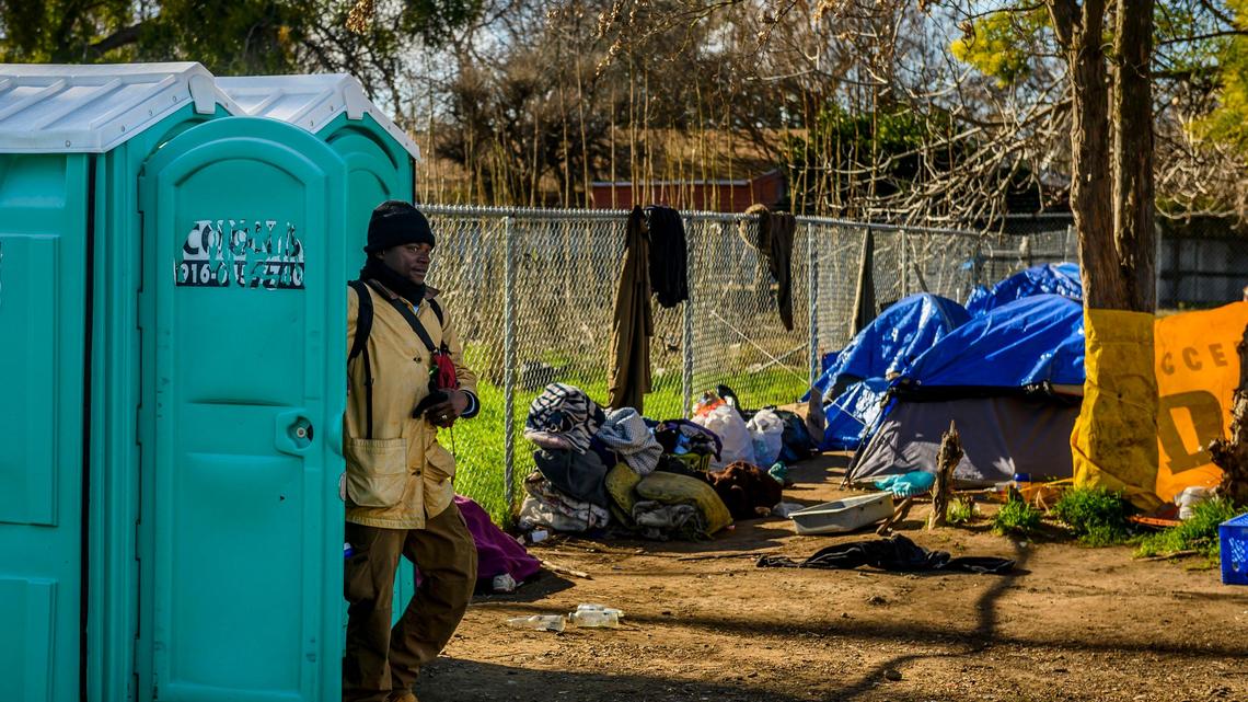 Will Holmes, 30, a person experiencing homelessness since August of 2018, walks out of a portable toilet stationed near 7th and North B streets on Tuesday, Feb. 4, 2020. Attorney and homeless advocate Mark Merin has filed a federal suit against the city of Sacramento alleging officials removed portable toilets that had been donated for homeless residents near 7th and North B streets.